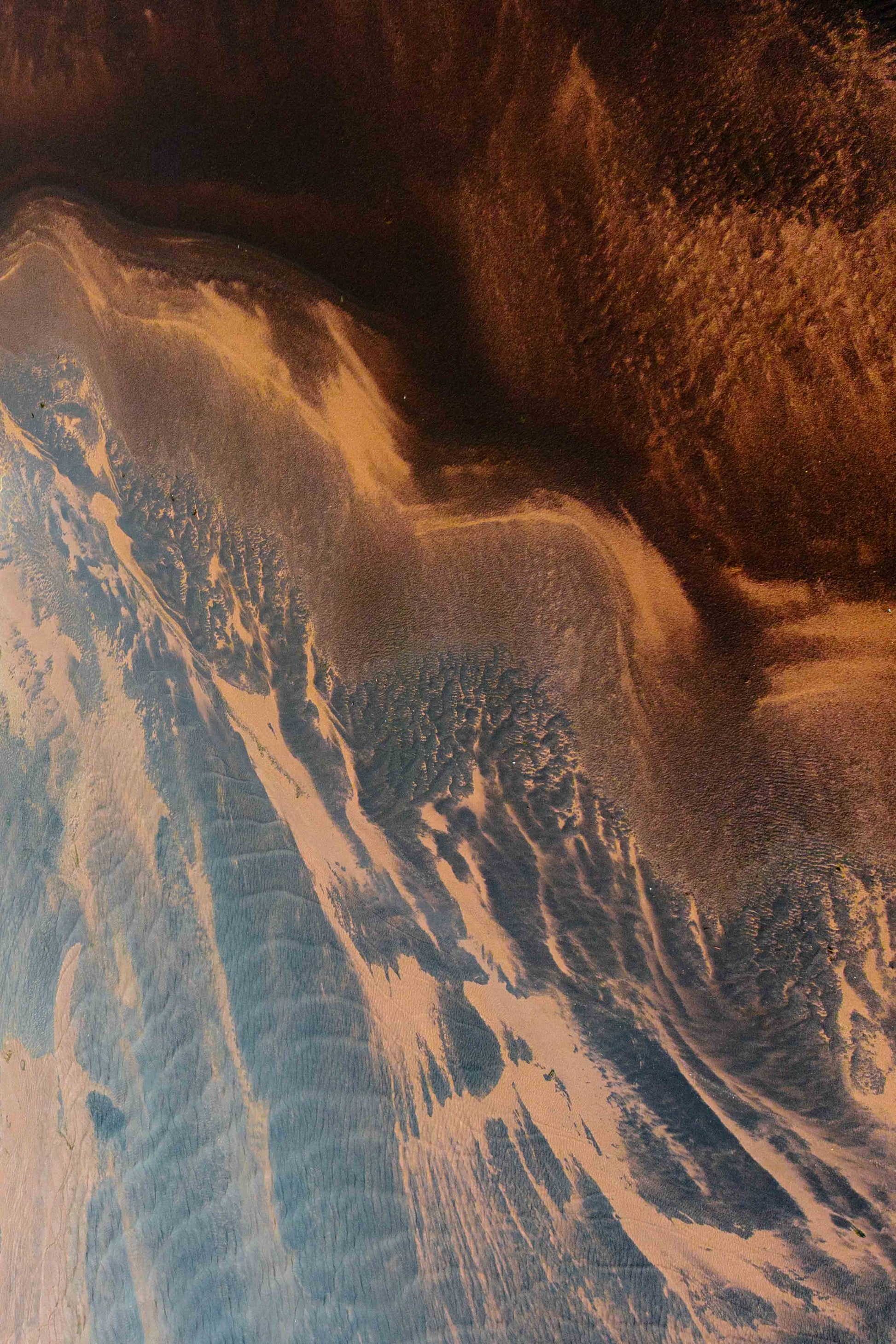 Patterns with colours draped by light and water and sand