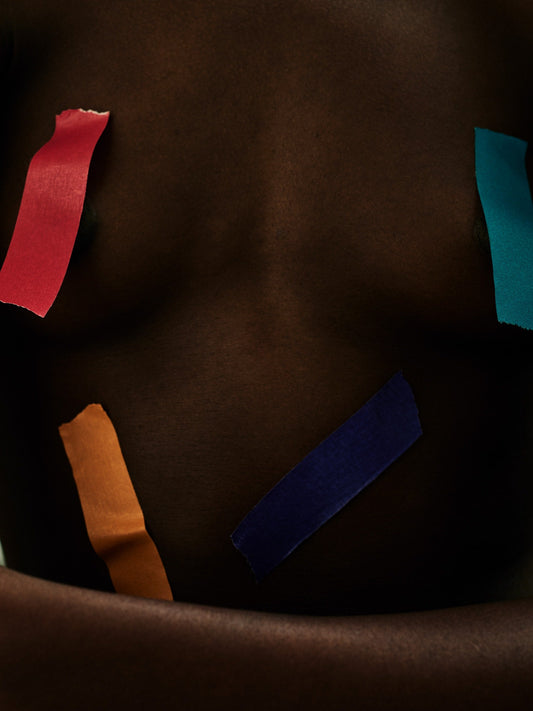 Gianluca Fontana's 'I take the clouds with me' - Bare torso with brightly colored tape covering intimate parts, dark brown skin, part of the Krops collection, created in London, 2018.