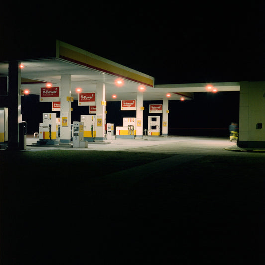 The artwork 'Exterior #5' by Jildo Tim Hof displaying a quiet gas station at night with as seen from the outside