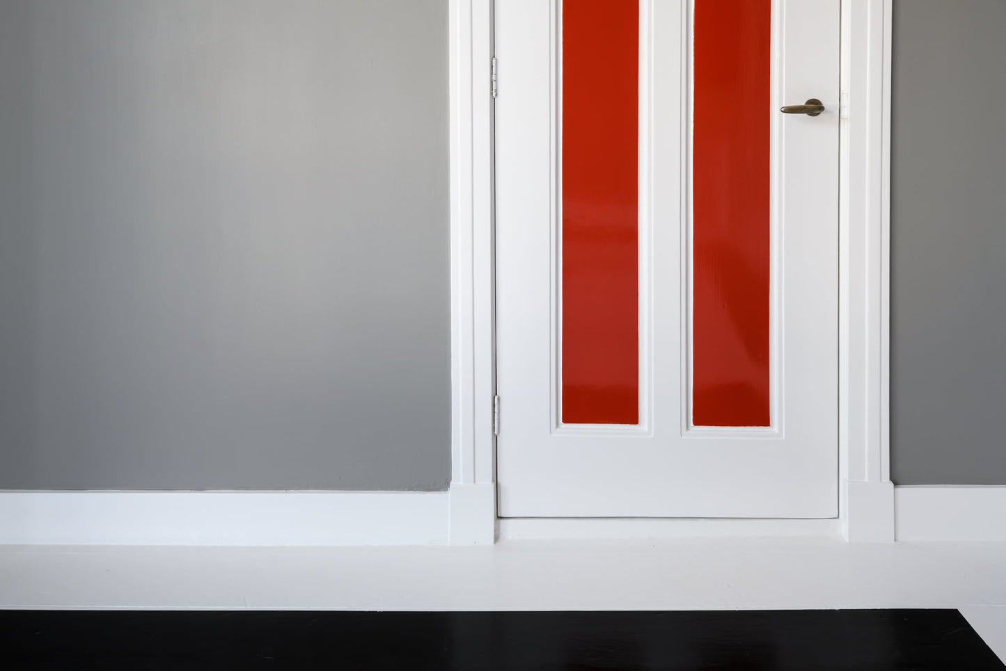 The artwork 'Van Doesburg-Rinsemahuis #6' by J.T. Hof displaying a grey wall and lower half of a white door with two red stripes