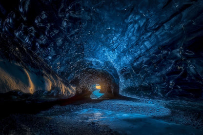 The artpiece 'A Glimpse of Light' by Markus van Hauten which shows a dimly lit, reflecting, almost magical looking ice cave.
