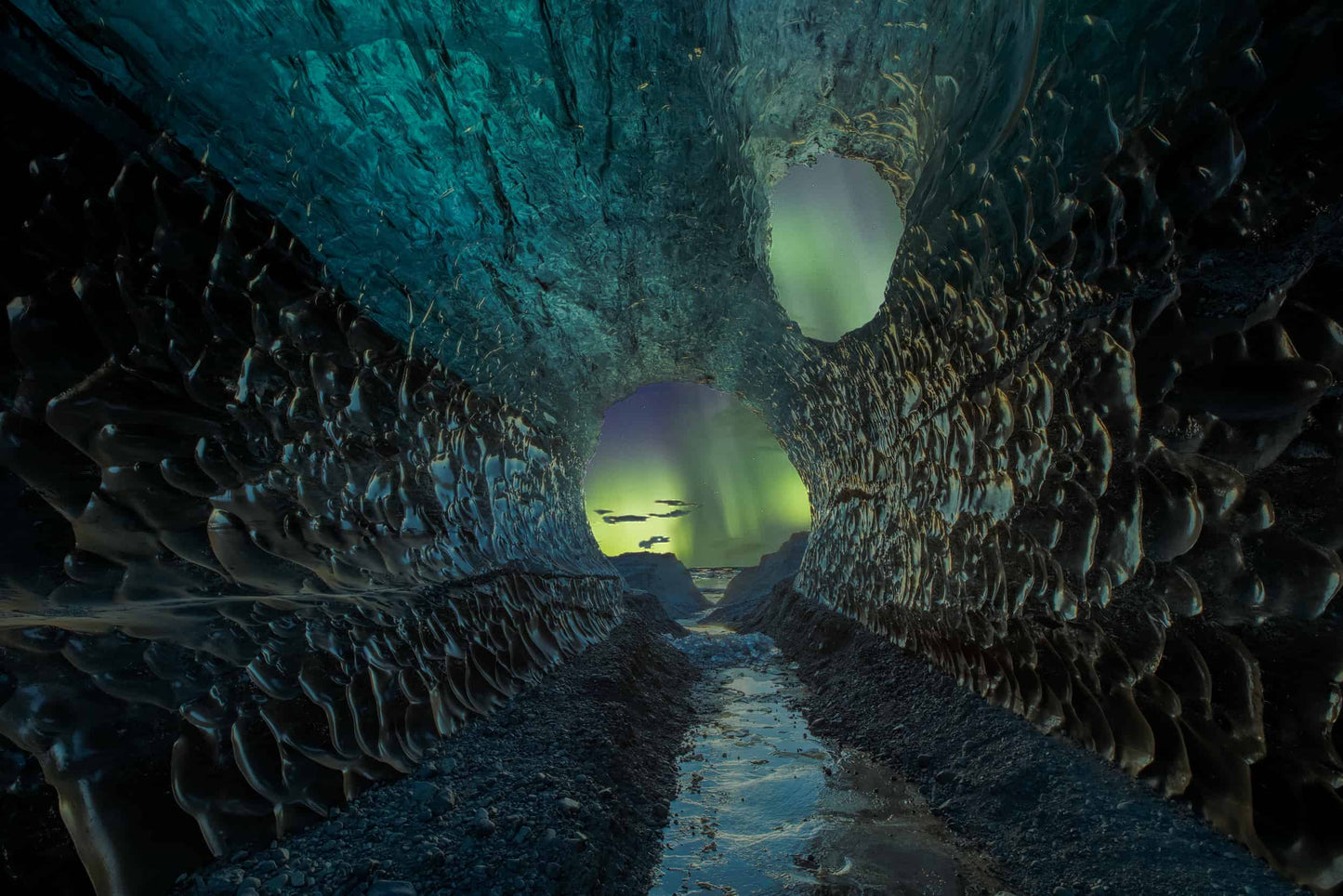 The artpiece 'Scattering Aurora' by Markus van Hauten which shows the aurora as seen from an ice cave, while the aurora is subtly lighting the cave walls.