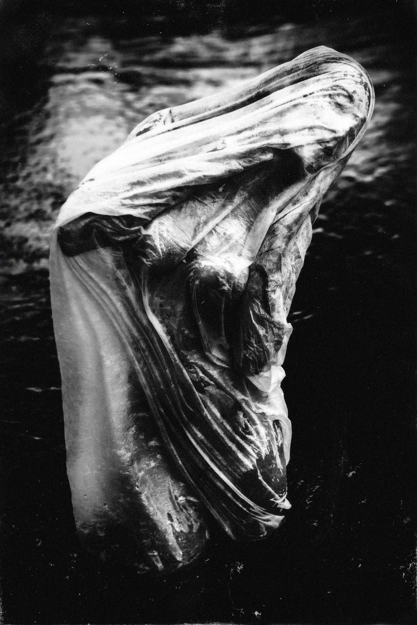 Fine artwork of an Eerie image of a woman standing in shallow water, draped in semi-transparent fabric, with facial features barely visible, captured by Ruslan Bolgov.