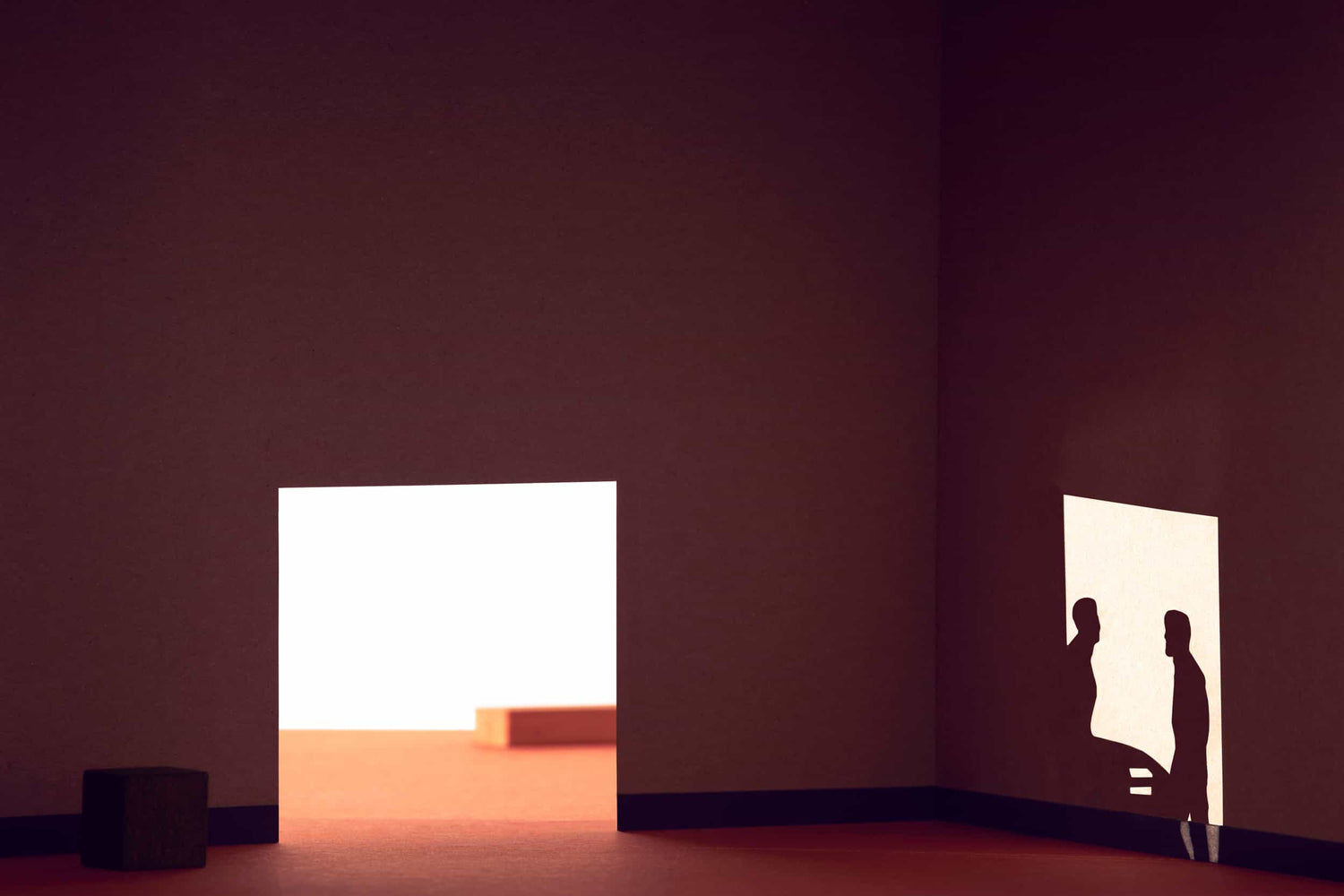 The artpiece 'Boys will be Boys' by Thomas van Schaik which shows a shadowplay in a room made from cardboard, with two men sitting and standing in a lighted area.